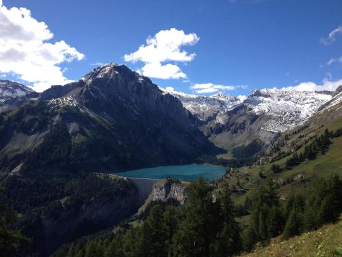 a view of a mountain range with a lake at Pension Les Audannes in Anzère