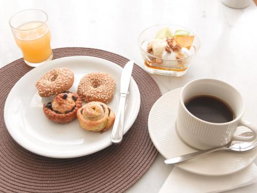 a plate of donuts and a cup of coffee at Londos Hotel in Piso Livadi