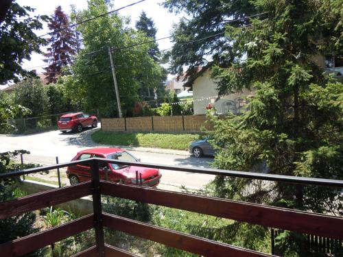 a red car is parked in a parking lot at Apartmani Sobe BILJANA in Arandjelovac