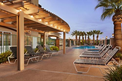 a patio with lounge chairs and a swimming pool at La Quinta by Wyndham St. George in St. George