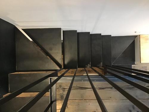 a room with black walls and a wooden floor at Apartmány Sebastian in Mikulov