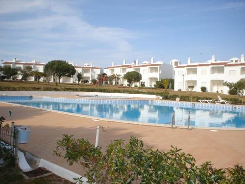 ein großer Pool vor einigen Gebäuden in der Unterkunft Quinta Do Torrejao in Armação de Pêra