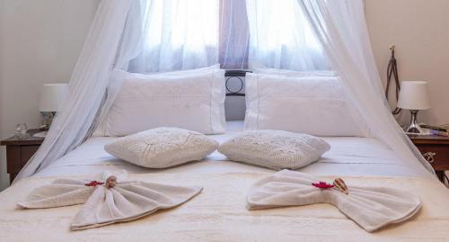 a bed with two towels on top of it at Elias Maro House in Avdou