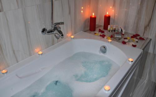 a bathroom with a tub with candles in it at Archontiko Chioti in Leonidion