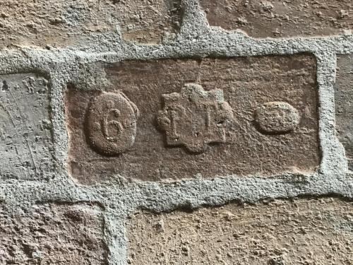 a stone wall with a sign on it at Apartmány Sebastian in Mikulov