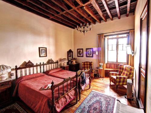 a bedroom with a bed with a red bedspread at Hotel Rural San Miguel - Only Adults in San Miguel de Abona