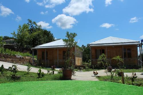 a house with a grass yard and a building at Green Villa Tskaltubo in Tskaltubo