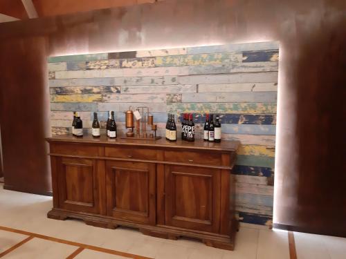 a bar with bottles of wine on a wall at Vivo Hotel in Pieve a Nievole