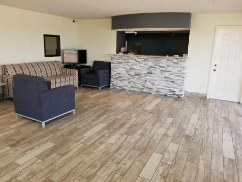 a living room with two chairs and a fireplace at Inn Of Rockwall in Rockwall