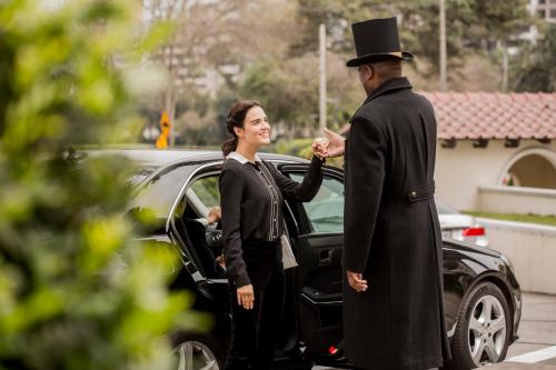 a woman in a top hat standing next to a man at Country Club Lima Hotel – The Leading Hotels of the World in Lima