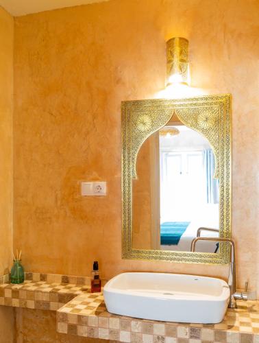 a bathroom with a large mirror and a tub at El Hotelito del Cotillo - Adults Only in El Cotillo