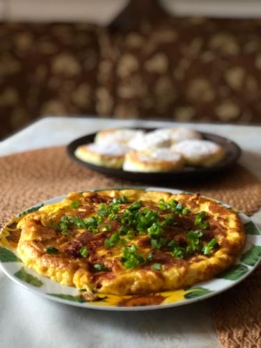 a pizza on a plate on a table at Karpatska Mria in Yaremche