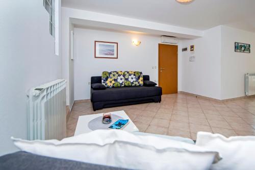 a living room with a couch and a table at Apartments Vanda in Rovinj