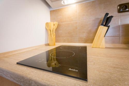 a tablet on a kitchen counter with a cutting board at Penzion Rita in Lišov