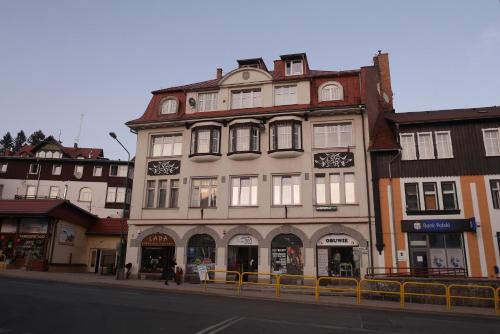 a building on the side of a city street at Apartamenty pod Jedynka - Jednosci Narodowej 3/1 in Szklarska Poręba