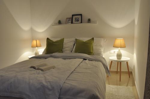 a bedroom with a bed with a book on it at Apartments Via Sole Dramalj in Dramalj