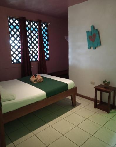 a bedroom with a bed with a dog laying on it at Tortuguero Adventures Beach House in Tortuguero