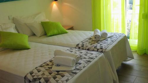 a hotel room with a bed with towels on it at D.ANA GUESTHOUSE in Lagos