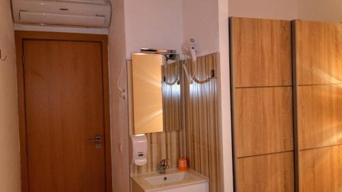 a bathroom with a toilet and a sink and a mirror at D.ANA GUESTHOUSE in Lagos