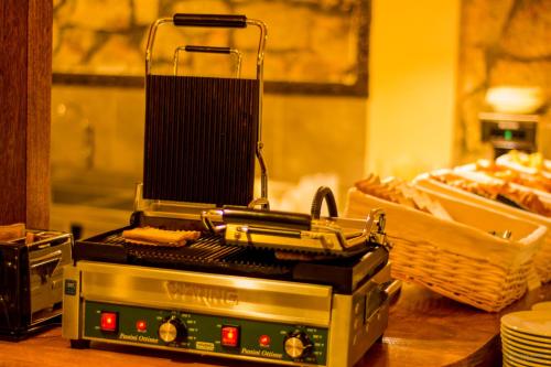 a grill sitting on top of a table with bread at Gringo Bill's Boutique Hotel in Machu Picchu