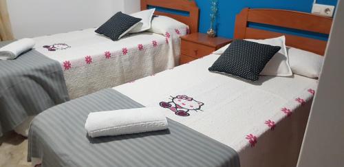 a room with two beds with towels on them at RINCON DO MAR ArenaBlanca in A Guarda
