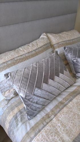 a bed with two pillows on top of it at Luxury Apartment Bewdley Worcestershire in Bewdley