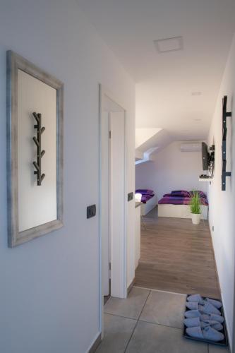 a hallway with white walls and a framed picture on the wall at Apartment Harmony in Ljubljana