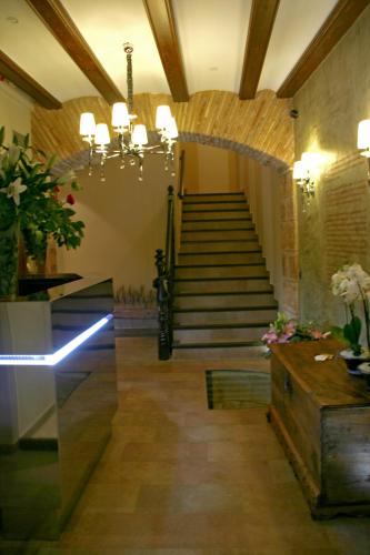 a lobby with a staircase and a stair case at Hotel Castillo de Alquézar in Alquézar