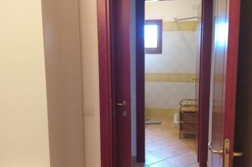 an open door to a bathroom with a tile floor at Strategico Ungaretti in Olbia