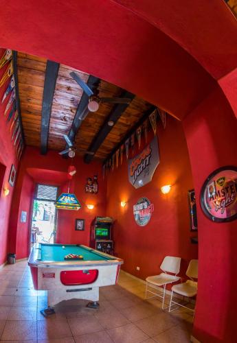 a room with a pool table in a restaurant at Island Life Hostel in Santo Domingo