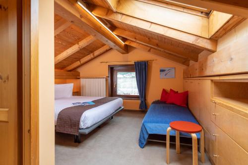 Un dormitorio con 2 camas y una mesa en una habitación en Chalet Rin Star, en Livigno