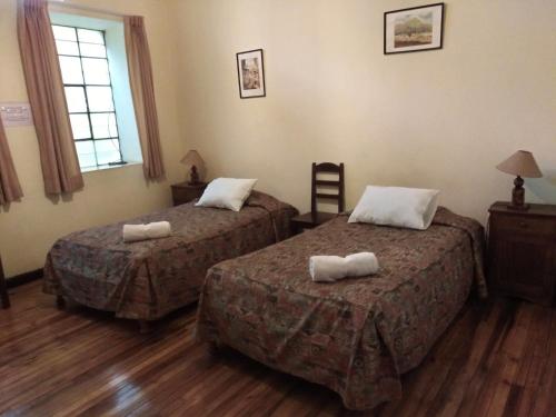 El Tuco Hotel tesisinde bir odada yatak veya yataklar