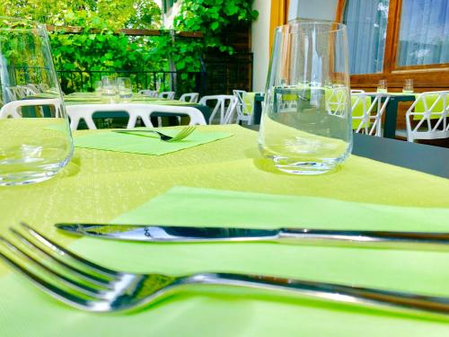 a table with two forks and two glasses on it at Hotel Adore in Romanel-sur-Lausanne