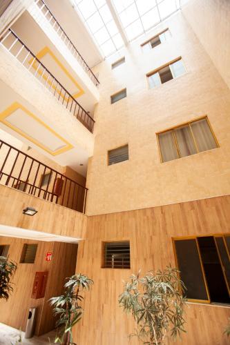 a large building with windows and plants at Hotel Tres Colonias - Sólo Adultos in Mexico City