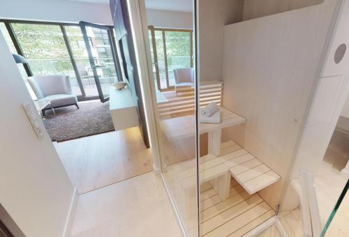 Habitación con una puerta de cristal que da a una sala de estar. en White Pearl Apartment 3.10, en Timmendorfer Strand