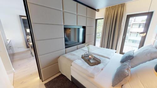 a hotel room with two beds and a tv at White Pearl Apartment 3.10 in Timmendorfer Strand