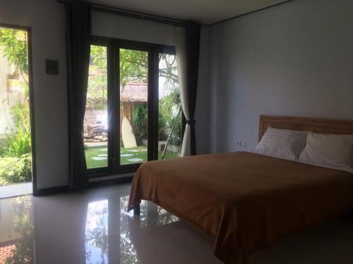 Postel nebo postele na pokoji v ubytování Bali Full Moon Guest House