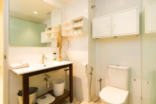 a bathroom with a toilet and a sink at Parkview Suites KLCC by Airhost in Kuala Lumpur