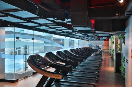 a row of treadmills in a building with a window at Shanghai Pagoda INNO Hotel in Shanghai