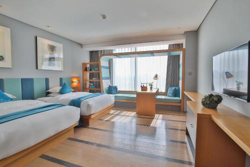 a bedroom with two beds and a flat screen tv at Shanghai Pagoda INNO Hotel in Shanghai