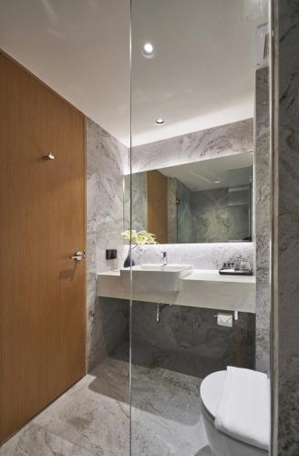 a bathroom with a sink and a toilet at Has Pattaya in Pattaya South