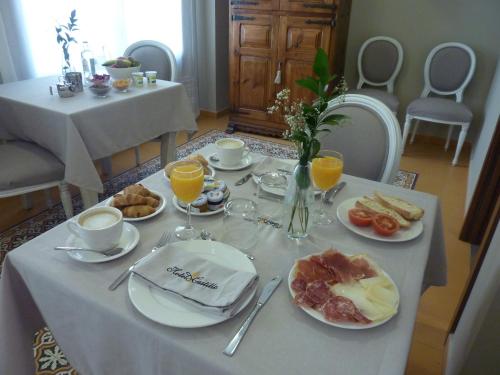a table with plates of breakfast food on it at Hotel Castillo de Alquézar in Alquézar