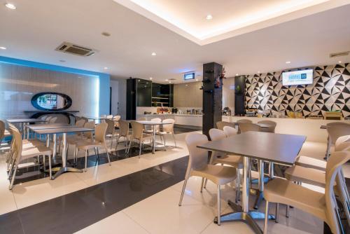 a dining room with tables and chairs in a restaurant at Hotel 88 Mangga Besar Raya 120 Jakarta By WH in Jakarta