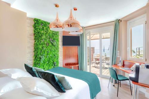 Best Western Plus Hôtel la Rade في كاسيس: غرفة نوم بسرير وجدار أخضر