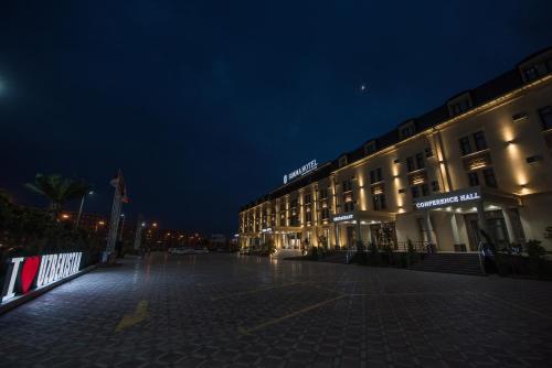 a night view of a building at night at Simma Hotel Spa & Waterpark in Tashkent