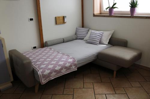 a bed and a chair in a room at IL LILLA in Ankaran