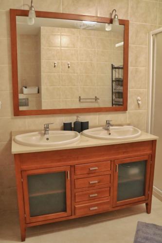a bathroom with two sinks and a large mirror at Home Sweet Home with Ocean View in Costa Calma