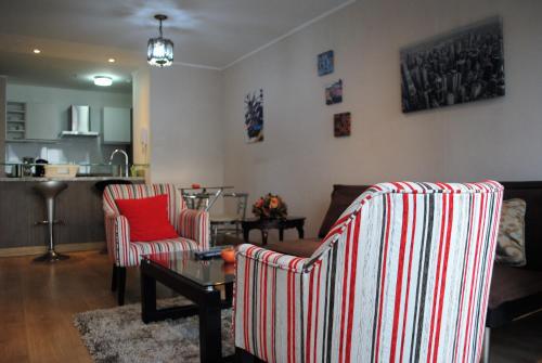 a living room with two chairs and a coffee table at GL Apts, rent Upper Pardo Miraflores - Suite 1 Hab in Lima