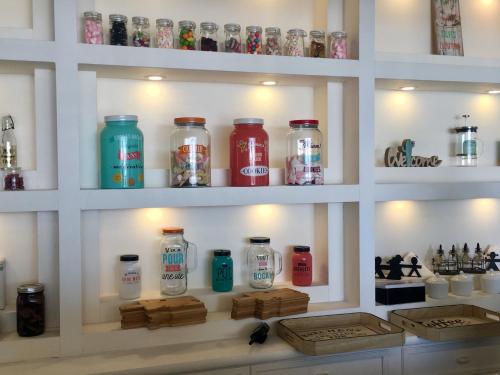 a shelf filled with lots of different colored bottles at St Paul Resort in Safra