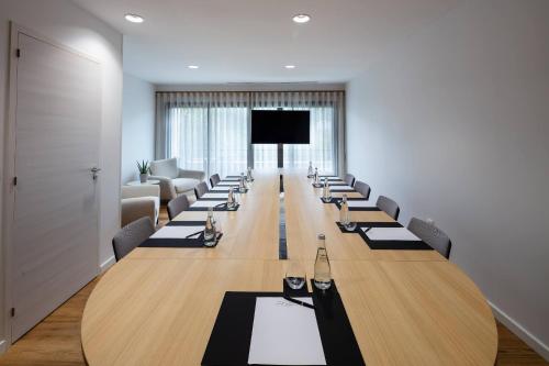 a large conference room with a long table and chairs at Hôtel Sainte Victoire in Vauvenargues